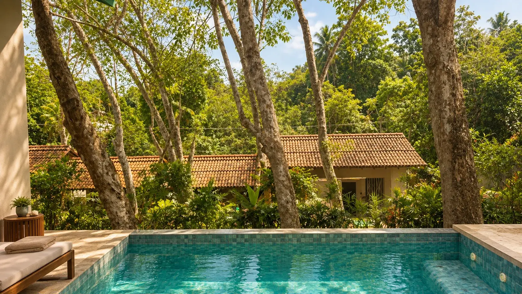 Villa Three's private plunge pool shaded by tall rubber trees